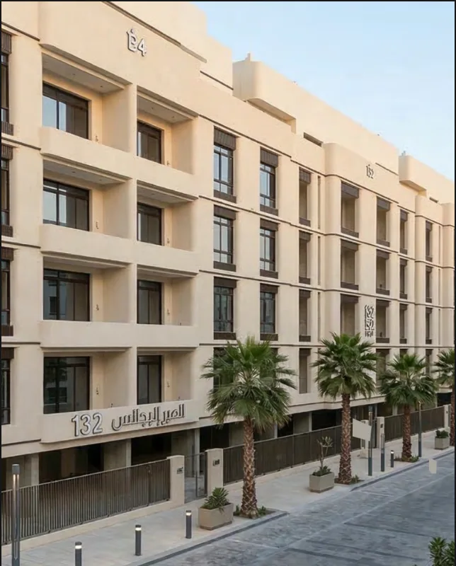 Close-up angled view of the building's facade, showing window details and balconies with tan/beige finish.