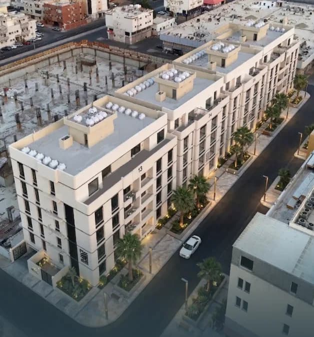 Aerial view of the building complex showing the rooftop, street layout, and landscaped surroundings.